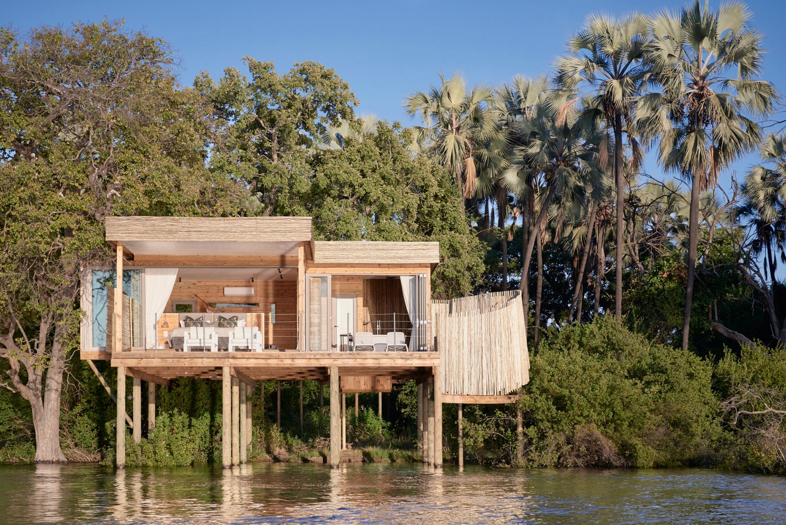 Victoria Falls River Lodge Sundowner Travel   VFRL Island Treehouse Exterior From Water Scaled 