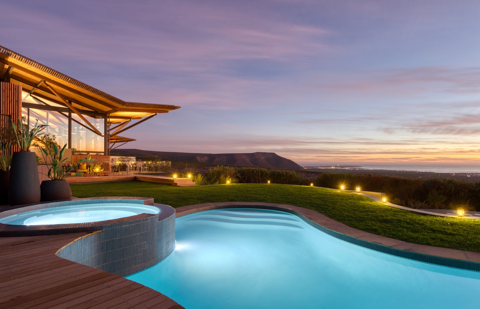 Grootbos Garden Lodge Pool mit Laternen beleuchtet im Sonnenuntergang mit Blick auf den Ozean