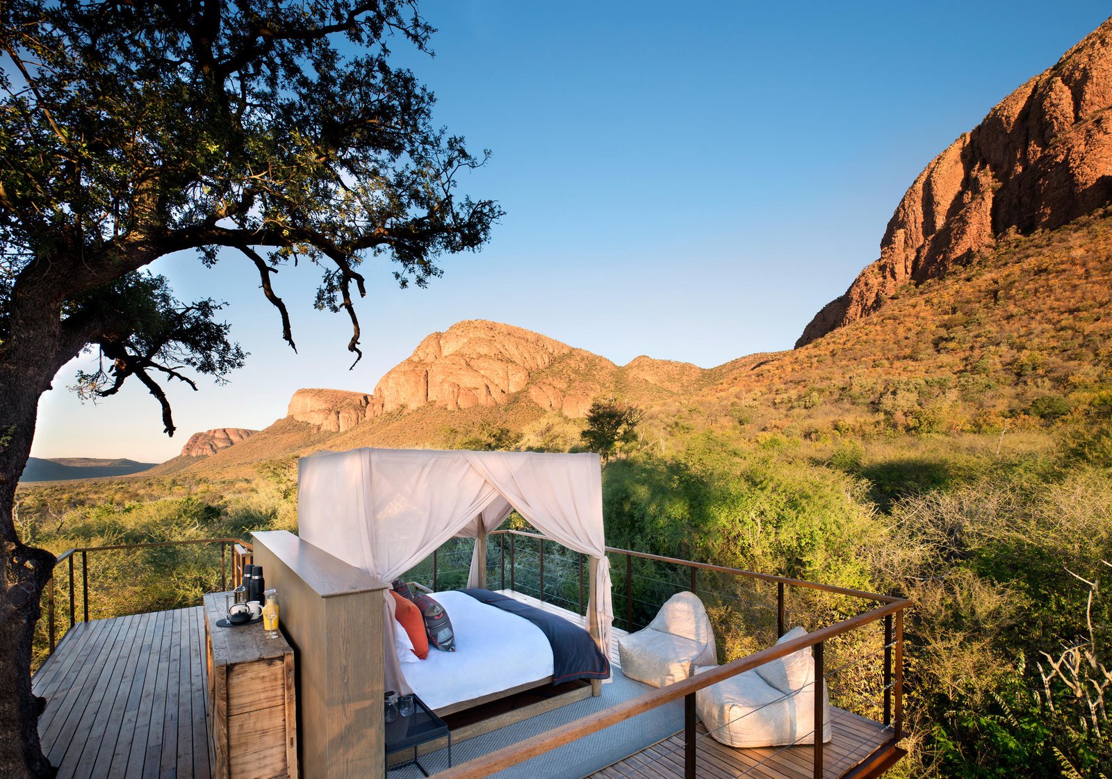 Sleep-out-Deck mit Bett inmitten der Natur